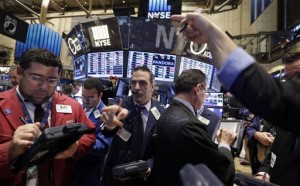 Traders work Wednesday on the floor of the New York Stock Exchange. Major stock indexes traded in a tight range in the early going as investors waited for word from the Federal Reserve and mulled over a mixed batch of earnings results.Associated Press