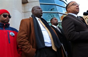 Michael Brown family attorneys Anthony Gray, right, and Benjamin Crump join Michael Brown’s stepfather Louis Head, left, at a news conference Thursday in Clayton, Mo.Associated Press