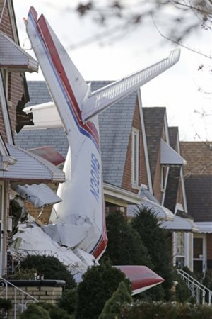 The wreckage of a small plane  which crashed stands upright in a home in Chicago early Tuesday.Associated Press