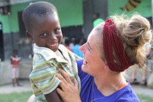 Katy junior Maggie Saint John holds one of the orphans from All Nations Charity Home in Ghana.Courtesy Art