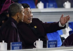 U.S. President Barack Obama, left, chats with Chinese President Xi Jinping as they prepare to watch a fireworks show after a welcome banquet for the Asia Pacific Economic Cooperation summit Monday in Beijing, China.Associated Press