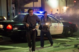 Jake Gyllenhaal, left, and Riz Ahmed appear in a scene from the film “Nightcrawler.” They portray freelance videographers who document police and rescue activity for a local Los Angeles news station.Associated Press
