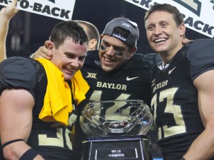 Senior nickelback Collin Brence, quarterback Bryce Petty and receiver Clay Fuller pose with the Big 12 Championship trophy after Baylor's 38-27 win over Kansas State.Skye Duncan | Lariat Photographer