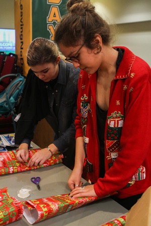 Students wrap presents Wednesday in the Bill Daniel Student Center for Santa’s Workshop.Carlye Thornton | Lariat Photo Editor