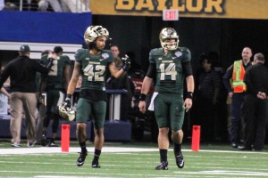 ARLINGTON -- Seniors Bryce Petty and Levi Norwood walk off the field after losing in the Cotton Bowl to Michigan State.Skye Duncan | Lariat Photo Editor