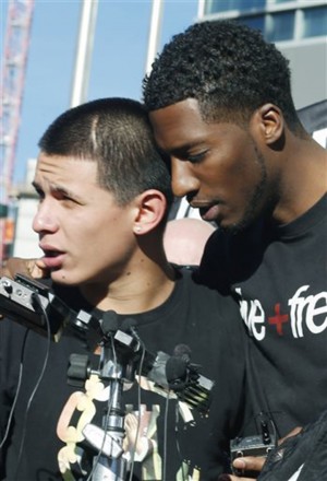 Activist Anthony Grimes, right, consoles Jose Castaneda as he waits to speak about his cousin who was killed in an incident with Denver Police as they head into a meeting on Tuesday, Jan. 27, 2015,  with officials of the Denver District Attorney's office. The fatal shooting of the 17-year-old girl took place after she allegedly hit and injured a Denver Police Department officer while driving a stolen vehicle early Monday in a northeast Denver alleyway. (AP Photo/David Zalubowski)