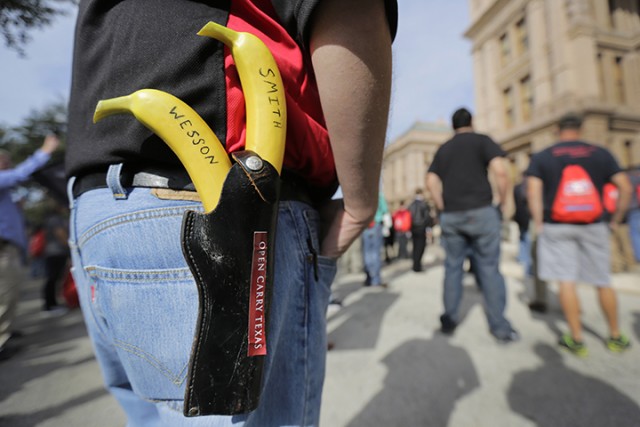 Jason Green wears a holster with bananas marked "Smith" and "Wesson" at a rally in support of open carry gun laws at the Capitol, Monday, Jan. 26, 2015, in Austin, Texas. (AP Photo/Eric Gay)