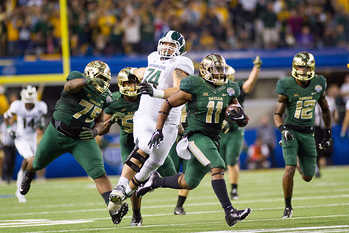 Freshman weakside linebacker Taylor Young runs from the Michigan State offense after an interception during Baylor's 42-41 loss in the Cotton Bowl on Jan. 1. Despite being rated a two-star prospect out of high school, the DeSoto native was named a Freshman All-American and Big 12 Defensive Newcomer of the Year by the AP.  Drew Mills | Roundup Photo Editor 