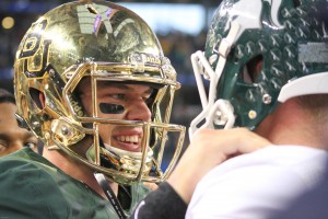 DALLAS -- Senior quarterback Bryce Petty congratulates a Michigan State player after Baylor's loss in the Cotton Bowl.Skye Duncan | Lariat Photo Editor