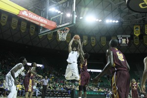 Junior forward Rico Gathers skies for a dunk against Huston-Tillotson on Wednesday. Gathers led the No. 21 Bears to an 81-61 win and broke a 60-year-old Baylor record with 28 rebounds. 