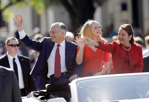Texas Gov. Greg Abbott, left, with daughter Audrey, center, and wife, Cecilia, waves during an inauguration parade, Tuesday, Jan. 20, 2015, in Austin, Texas. (AP Photo/Eric Gay)