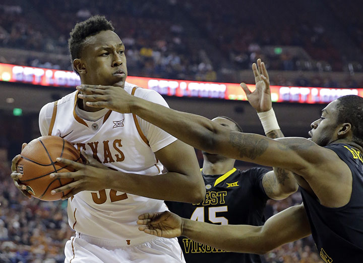 Texas' Myles Turner (52) is pressured by West Virginia's Elijah Macon (45) and BillyDee Williams, right, during the first half of an NCAA college basketball game, Saturday, Jan. 17, 2015, in Austin, Texas.Associated Press