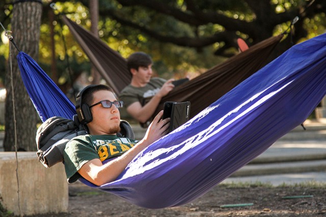 Midland freshman Anthony Madrid studies in his hammock in Vara Martin Daniels Plaza on January 27, 2015. Temperatures peaked at 82 degrees on Tuesday, bringing many students outdoors to enjoy the warm temperatures. Kevin Freeman | Lariat Photographer