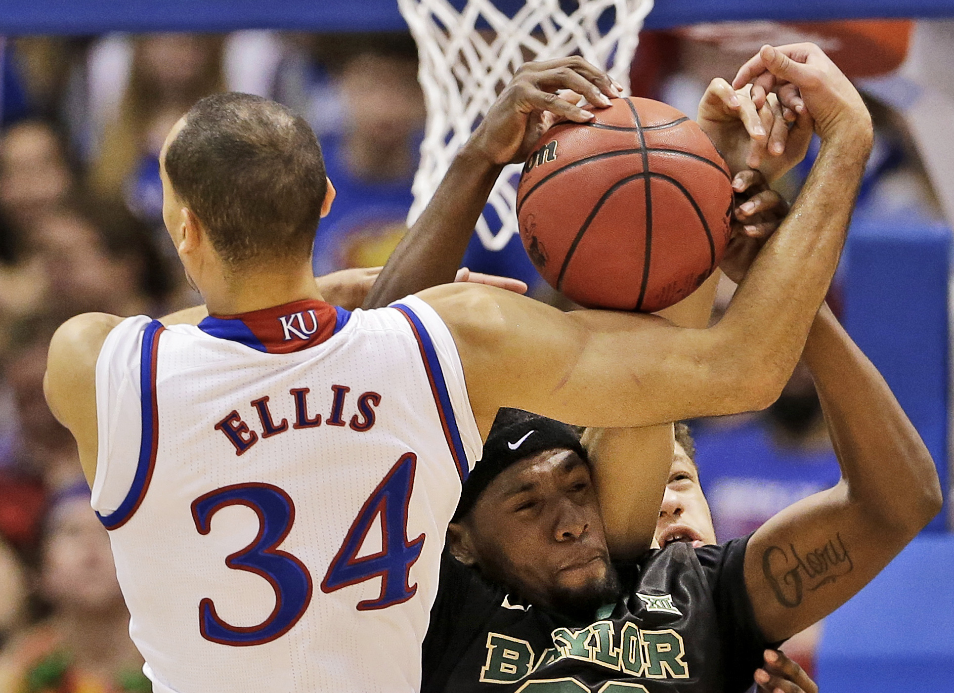 Kansas's Perry Ellis (34) and Royce O'Neale (00) battle for a rebound during the first half of an NCAA college basketball game Saturday, Feb. 14, 2015, in Lawrence, Kan. Associated Press