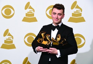 Sam Smith poses in the press room with the awards for best new artist, best pop vocal album for “In the Lonely Hour”, song of the year for “Stay With Me”, and record of the year for “Stay With Me” at the 57th annual Grammy Awards at the Staples Center on Sunday, Feb. 8, 2015, in Los Angeles. (Associated Press)