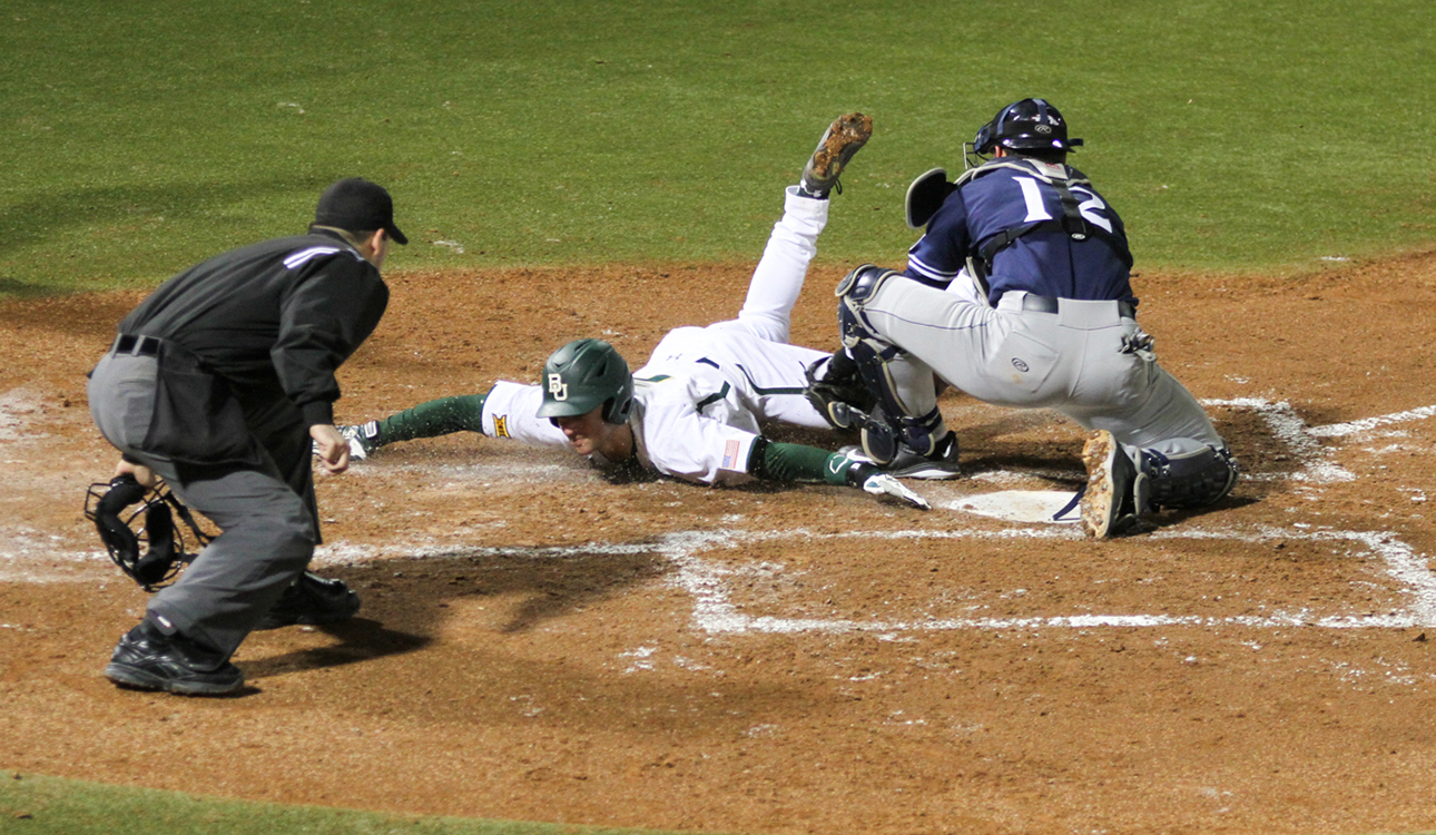 Freshman infielder Steven McLean beats the throw and steals home during Baylor baseball’s game against Dallas Baptist University. McLean scored two runs, but the Bears fell 9-6. Skye Duncan | Lariat Photo Editor