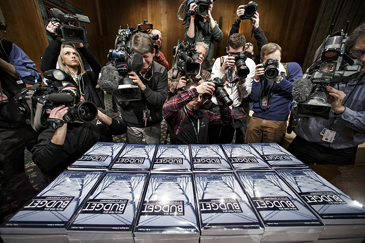 Media surrounds as President Barack Obama's new $4 trillion budget plan is distributed by the Senate Budget Committee as it arrives on Capitol Hill in Washington on Monday.Associated Press