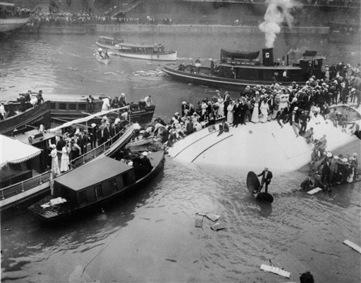  In this July 24, 1915 file photo, passengers are rescued as they stand atop the Eastland passenger ship after the vessel capsized in the Chicago River in downtown Chicago. Film clips have surfaced of the 1915 disaster that left 844 people dead. The first-known footage of the Eastland disaster was spotted by Jeff Nichols, a doctoral student at the University of Illinois at Chicago who was looking through seemingly unrelated material on World War I. (AP Photo)