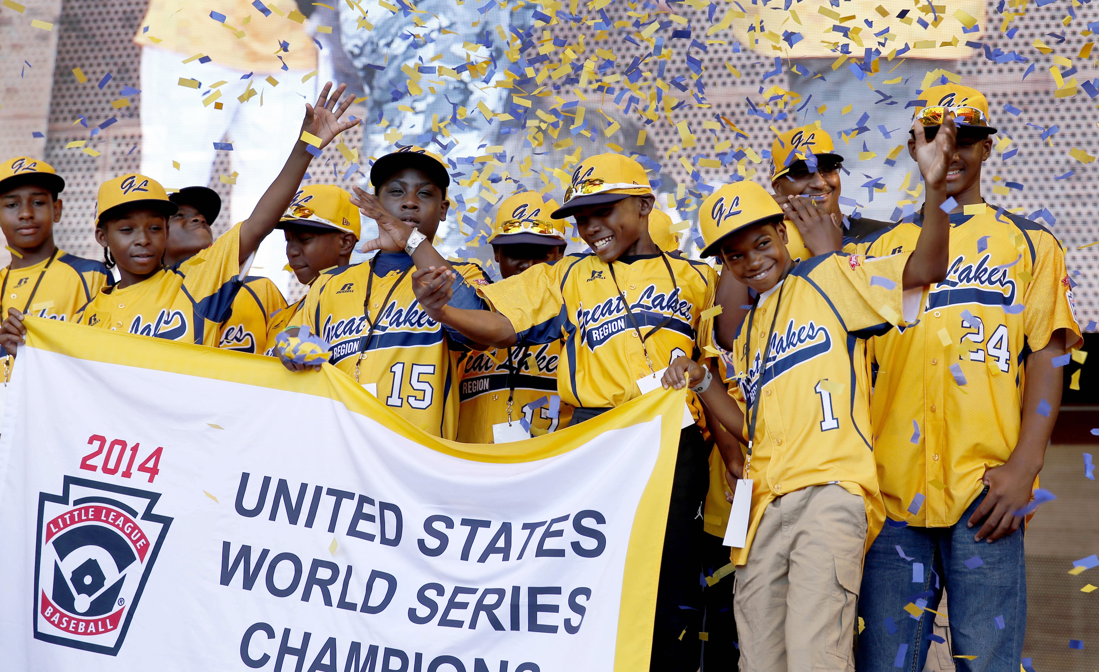 FILE - In this Aug. 27, 2014, file photo, members of the Jackie Robinson West Little League baseball team participate in a rally celebrating the team's U.S. Little League Championship in Chicago. Little League International has stripped Chicago's Jackie Robinson West team of its national title after finding the team falsified its boundary map. The league made the announcement Wednesday morning, Feb. 11, 2015, saying the Chicago team violated regulations by placing players on the team who didnt qualify because they lived outside the teams boundaries. Little League International also suspended Jackie Robinson West manager Darold Butler from league activity. Associated Press