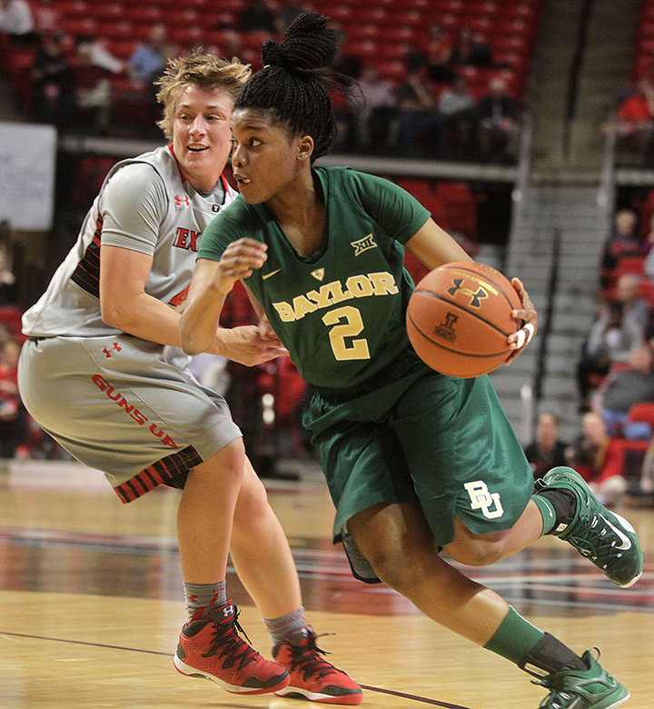 Baylor's Niya Johnson drives past Texas Tech's Ryann Bowser during an NCAA college basketball game in Lubbock, Texas, Wednesday. Associated Press