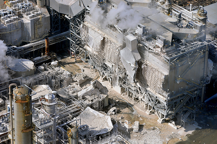 A structure is damaged after an explosion in a processing facility at the ExxonMobil refinery Wednesday in Torrance, Calif. A small ground fire was quickly extinguished and the facility’s flare system was triggered for safety reasons. Two workers suffered minor injuries. Associated Press