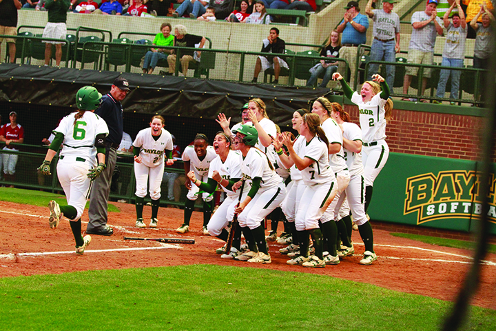 Baylor gathers at home plate to celebrate a home run against Oklahoma on April 11, 2014. The Bears will look to qualify for their second-straight WCWS appearance in 2015 and third in five seasons.Kevin Freeman | Lariat Photographer