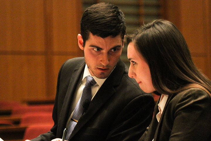 Fair Oaks Ranch junior Alex Oestreich whispers to Katy junior Lawren Kinghorn amid the plaintiff's monologue during McCahill, Hardy v. Kinghorn in the Law School 127 courtroom Wednesday. Kevin Freeman | Lariat Photographer