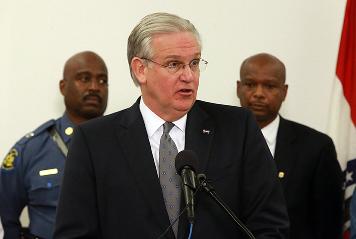 Missouri Gov. Jay Nixon, center, speaks at a news conference to announce law enforcement planning  with Missouri State Highway Patrol Capt. Ron Johnson, left, and Missouri Director of Public Safety Dan Isom in Nov. 2014 in St. Louis, Mo.  Associated Press