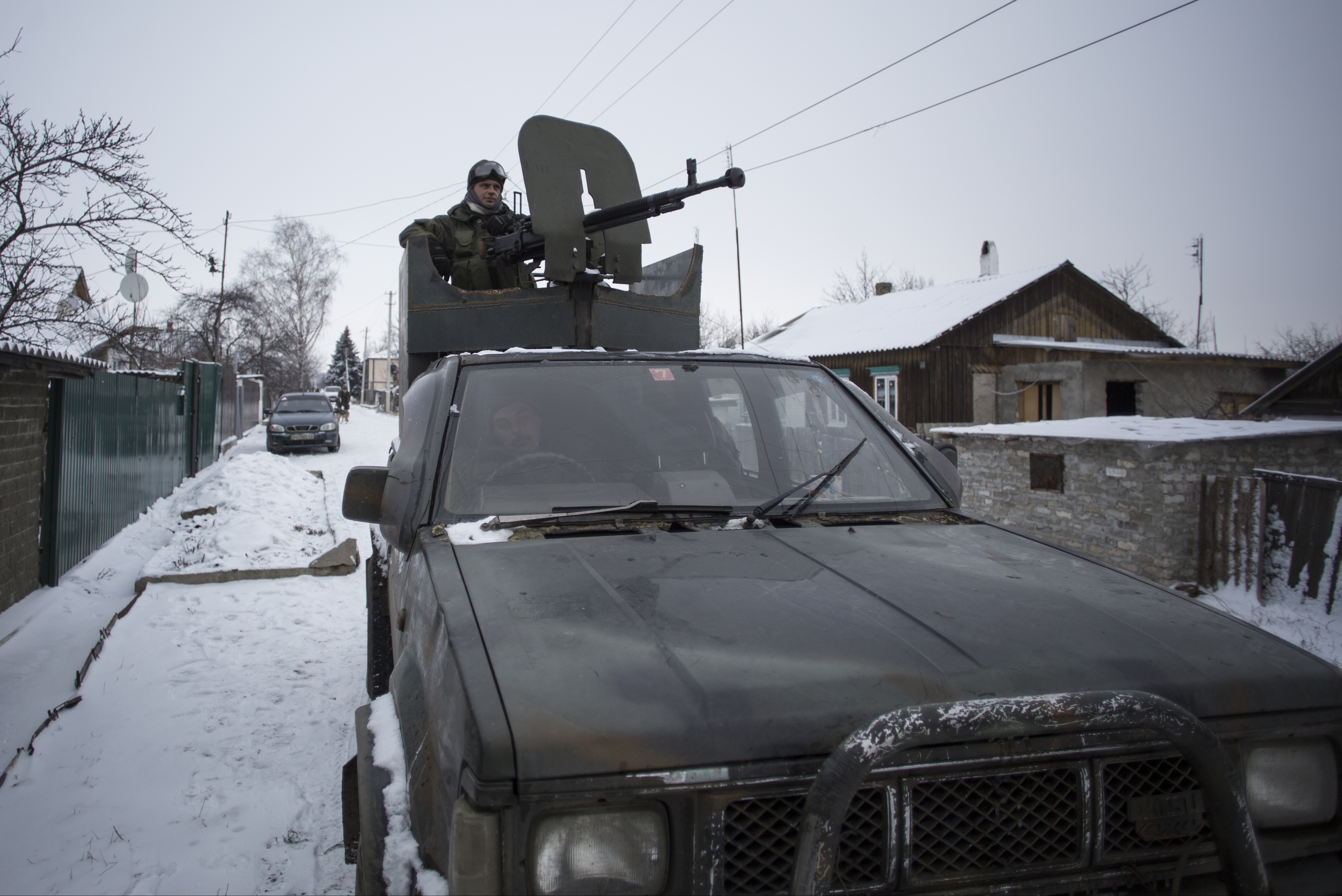 A pro-Russian rebel mans a weapon mounted on a pickup truck on Tuesday in the town of Vuhlehirsk, eastern Ukraine. Fighting in eastern Ukraine intensified on Tuesday ahead of much-anticipated peace talks, with both sides claiming significant advances.  Associated Press