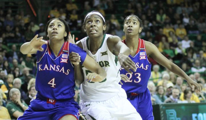 Sophomore post Khadijah Cave boxes out two Kansas defenders for a rebound during the Lady Bears' 66-58 win on Sunday. The Big 12 has continued to be the strongest conference in basketball.Skye Duncan | Lariat Photo Editor