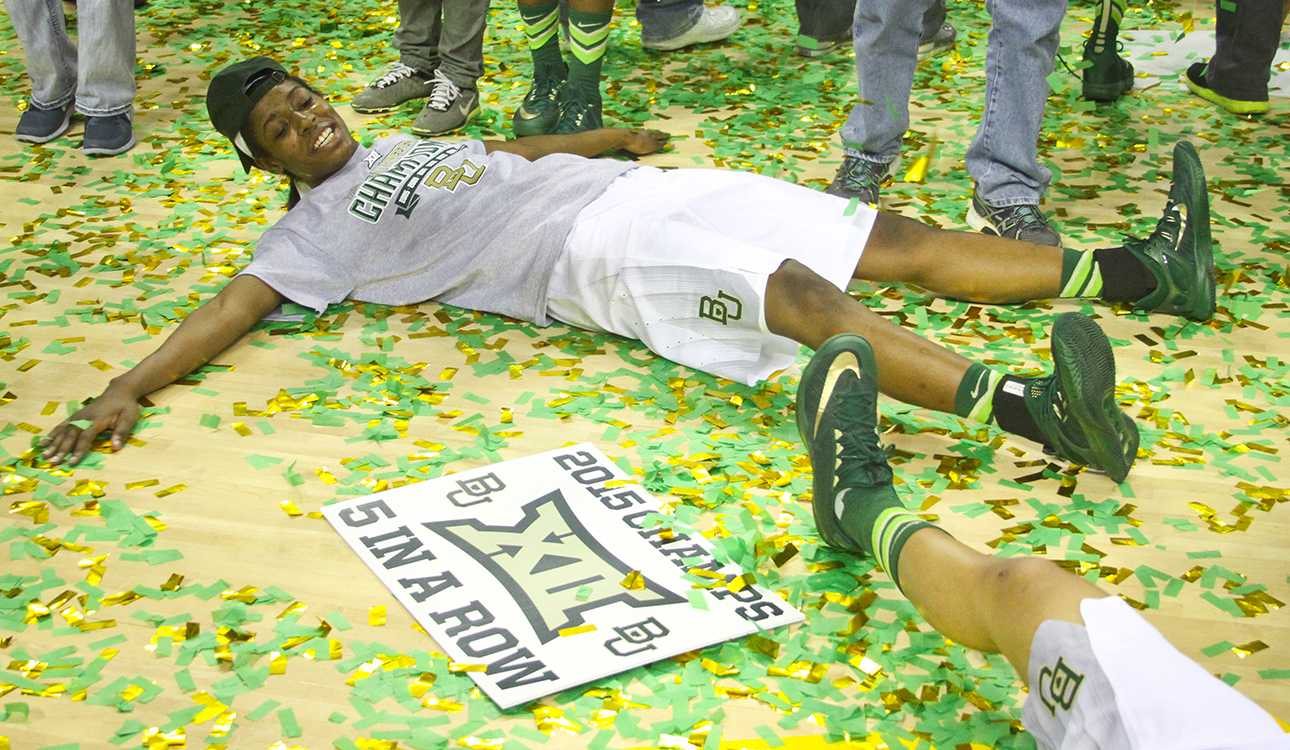 Sophomore post Khadijah Cave celebrates Baylor’s fifth-straight Big 12 Championship by making a confetti angel on the floor of the Ferrell Center after the Lady Bears’ 91-75 win on Saturday.  Jess Schurz | Lariat Photographer