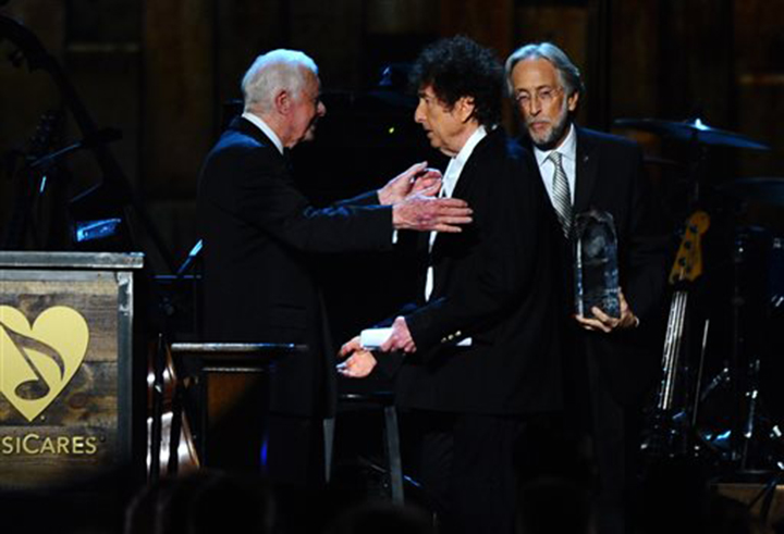 President Jimmy Carter, left, presents Bob Dylan with the award for 2015 MusiCares Person of the Year at the 2015 MusiCares Person of the Year show at the Los Angeles Convention Center on Friday, Feb. 6, 2015, in Los Angeles. (Associated Press)