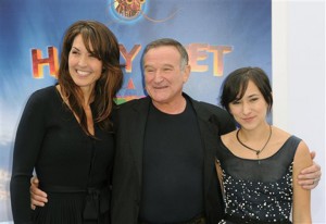 Susan Schneider, left, Robin Williams, and Zelda Williams arrive on Nov. 13, 2011, to the premiere of “Happy Feet Two” at Grauman’s Chinese Theater in Los Angeles. Associated Press