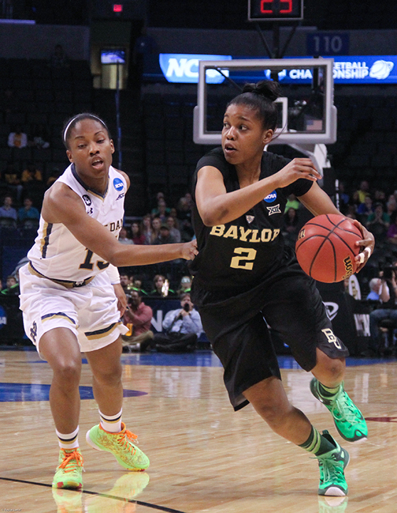 No. 2 junior guard Niya Johnson dribbles past a Notre Dame defender during the Lady Bears’ 77-68 loss in the regional final of the NCAA tournament at Chesapeake Energy Arena on Sunday night in Oklahoma City.  Skye Duncan | Lariat Photo Editor