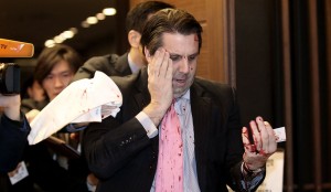 U.S. Ambassador to South Korea Mark Lippert leaves a lecture hall for a hospital Thursday in Seoul, South Korea. Lippert was attacked by a man wielding a razor and screaming that the Koreas should be unified.