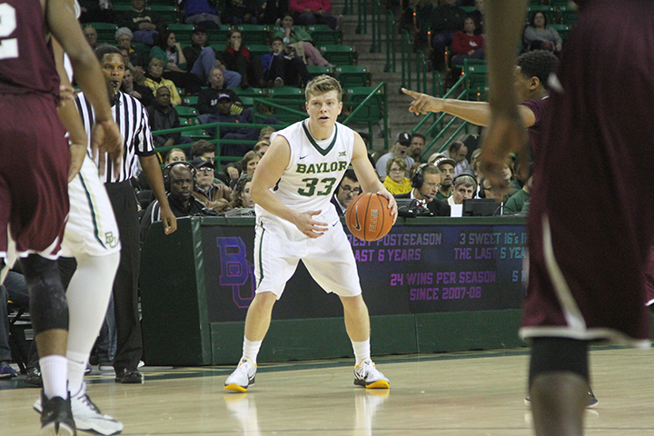 Junior point guard Austin Mills surveys the court in a game against the Texas Southern Tigers in December at the Ferrell Center. Skye Duncan | Lariat Photo Editor