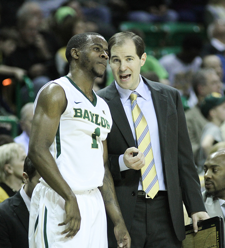 Head coach Scott Drew and senior guard Kenny Chery discuss a play during Baylor’s 74-65 loss to Oklahoma State on Feb. 9.  Skye Duncan | Lariat Photo Editor