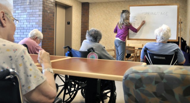 An instructor leads a word game for  nursing home residents in Lancaster, Pa. Recently, it has been found that the longer life expectancy in the U.S. is driving life insurance rates up nationwide.