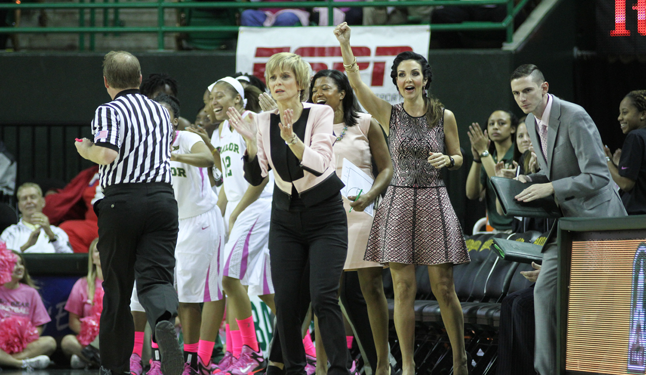 Head coach Kim Mulkey and her stuff applaud their team during the Lady Bears’ 79-51 win over the Mountaineers on Feb. 15 at the Ferrell Center. Baylor won its fifth-straight Big 12 Championship in 2014-15. Skye Duncan | Lariat Photo Editor