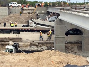 Authorities investigate a a tractor-trailer that crashed into an overpass under construction on Thursday, March 26, 2015 in Salado, Texas.    Associated Press