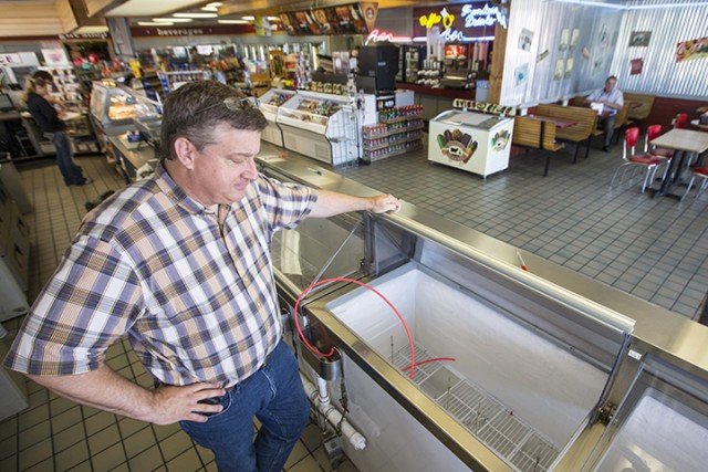 Brett Smith, owner of Scoops Ice Cream, looks over the empty ice cream case on Tuesday in Brenham. In compliance with the Blue Bell Ice Cream recall, Smith pulled all Blue Bell ice cream from his freezers.  Associated Press