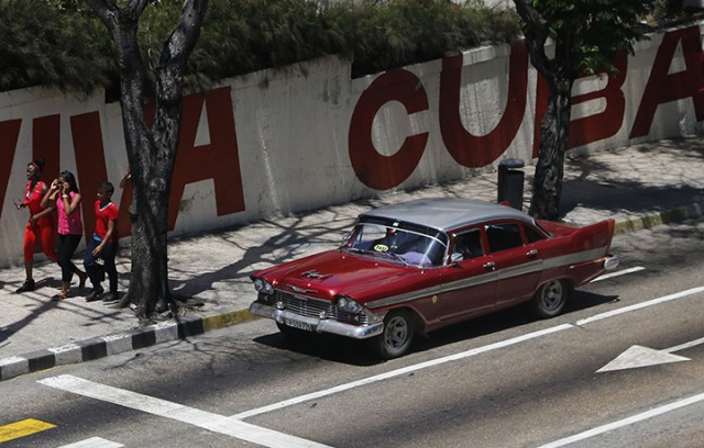 A taxi driver steers a classic American car Tuesday in Havana, Cuba. President Barack Obama will remove Cuba from the list of state sponsors of terrorism, the White House announced Tuesday, a key step in his bid to normalize relations between the two countries.  Associated Press