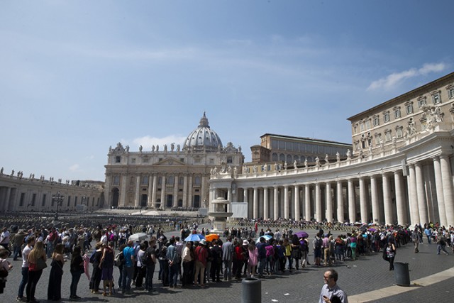 People line up to enter St. Peter's Basilica Wednesday at the Vatican. Vacations in Europe have a new attraction: the euro's steep drop in value is making the continent much cheaper for tourists from across the world.  Associated Press