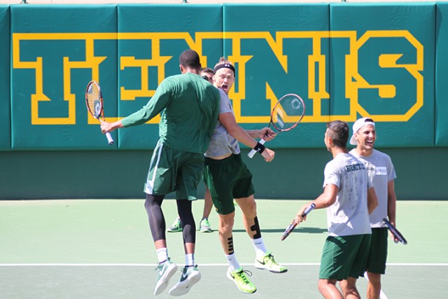 Freshman forward T.J Maston and sophomore tennis player Vince Schneider celebrate as the men’s basketball and tennis go through workouts togther on Wednesday at the Hurd Tennis Facility.  Skye Duncan | Lariat Photo Editor