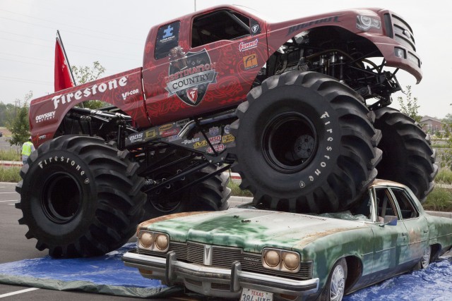 Corey Schlicher drives Bigfoot 8 onto a Baylor-themed car to announce the “No Limits Monster Truck World Championship” on Sept. 16 outside McLane Stadium. The event will be hosted at McLane on Saturday.   Jonothon S. Platt | Lariat Web & social media editor