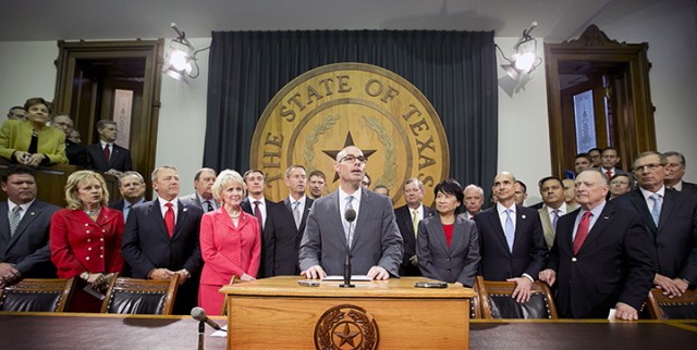 In this April 8, 2015 photo, Rep. Dennis Bonnen, center, surrounded by other representatives, announces his plan for a sales tax cut at the Capitol in Austin.  Associated Press