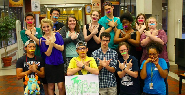 Members of The Whatever, an unchartered group on campus, display the group’s hand symbol. The group is performing random acts of kindness this week in honor of its event, #ArkWeek2015.  Courtesy Art