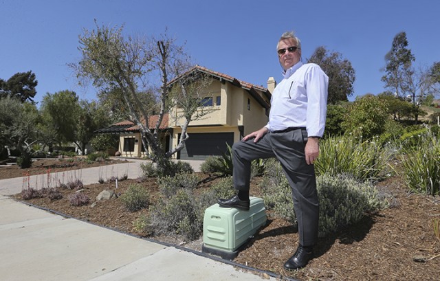 In this April 17, 2015 photo, Jim Reardon, who is awaiting a ruling from a California appeals court regarding his suit over tiered water rates, stands outside his home where he installed drought-tolerant landscaping in San Juan Capistrano, Calif.  Associated Press