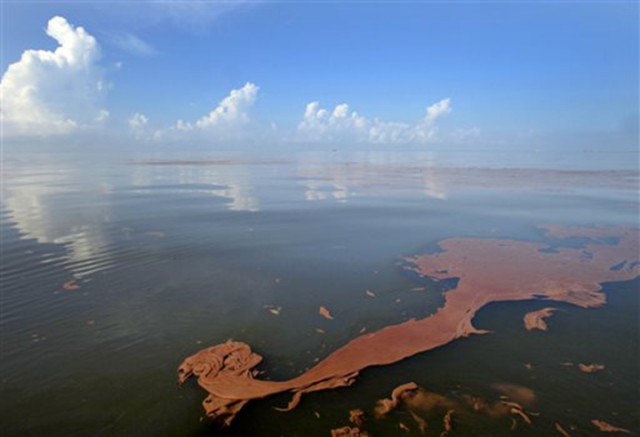 In this Monday, June, 7, 2010 file picture, oil from the BP Deepwater Horizon spill floats on the water with clouds reflected in the sheen on Barataria Bay off the coast of Louisiana.  Associated Press