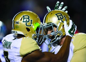 Baylor wide receiver KD Cannon, left, congratulates quarterback Jarrett Stidham, right, after a touchdown during the first half of an NCAA college football game against Kansas State in Manhattan, Kan., Thursday, Nov. 5, 2015. (AP Photo/Orlin Wagner)